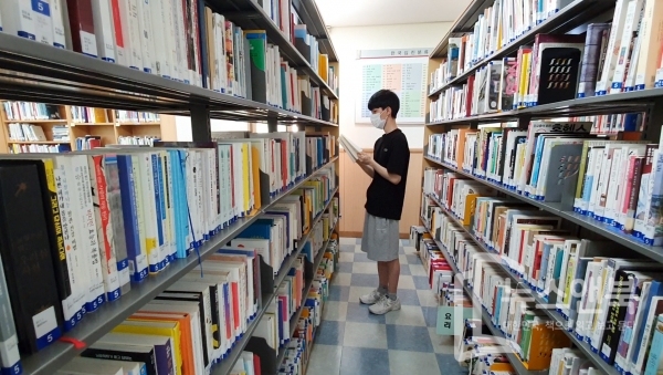 폭염이 물러가고 아침저녁으로 비교적 선선한 날씨를 보인 가운데 19일 대전 유성구 노은도서관에서 마스크를 쓴 학생이 고른 책을 읽고 있다.  전우용 기자